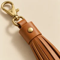 Fringe Charm, close-up of the rivet and folded edge