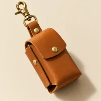 Mini Trine Charm, close-up of the rivet and folded edge